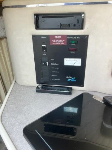 Slide: The Image of 1996 Sea Ray Sundancer control panel with electrical switches and gauges. - 5