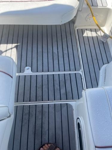Slide: The Image of 1996 Sea Ray Sundancer boat deck with gray flooring and white seating. - 7