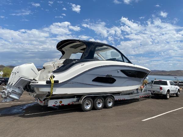 Slide: The Image of 2025 Sea Ray Sundancer 370 OB on trailer in parking lot. - 2
