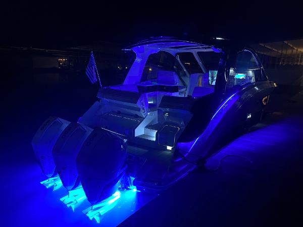 Slide: The Image of 2025 Sea Ray Sundancer 370 OB with blue underwater lights at night. - 22