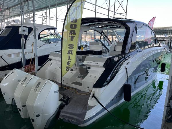 Slide: The Image of 2025 Sea Ray Sundancer 370 OB luxury boat on display at a marina. - 27