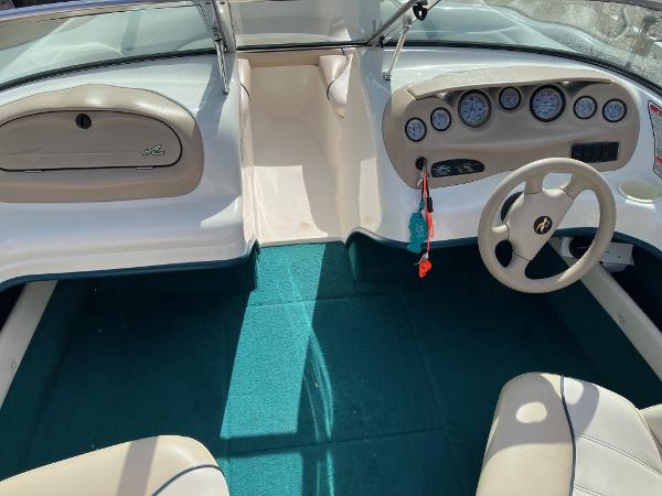 Slide: The Image of 1998 Sea Ray V180 boat interior with steering wheel and dashboard gauges. - 10