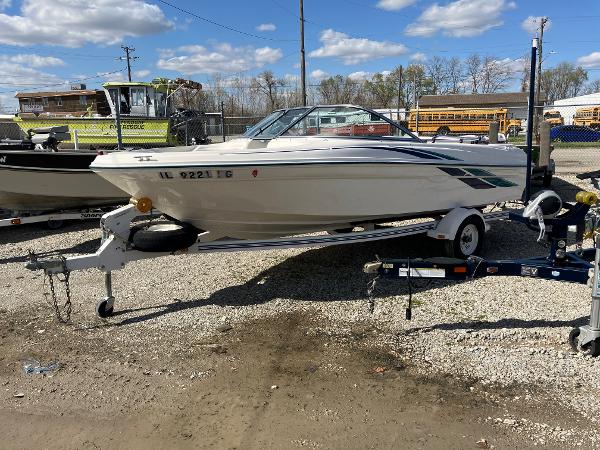 Slide: The Image of 1998 Sea Ray V180 boat on a trailer in a gravel lot. - 5