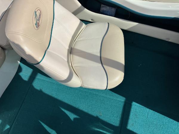 Slide: The Image of Sea Ray V180 1998 boat interior with white seat and teal carpet. - 8