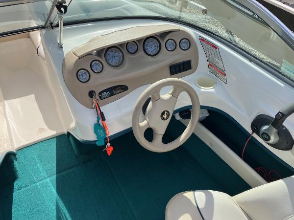 Slide: The Image of 1998 Sea Ray V180 boat dashboard with steering wheel and instrument panel. - 9