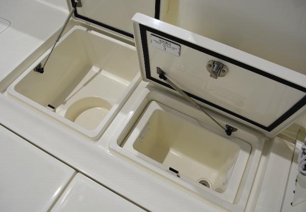 Slide: The Image of 2020 SeaVee 322z boat storage compartments with open lids. - 10