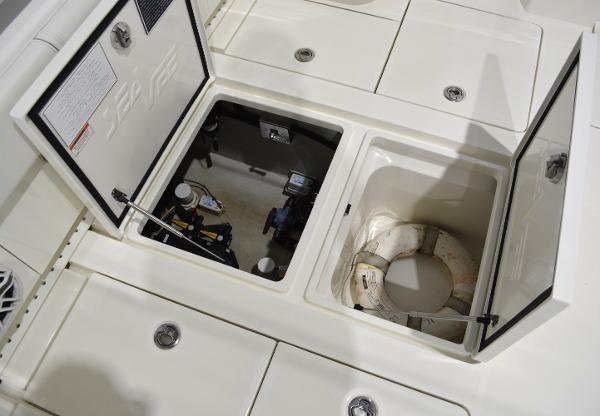 Slide: The Image of 2020 SeaVee 322z boat storage compartments with open hatches and life preserver. - 11