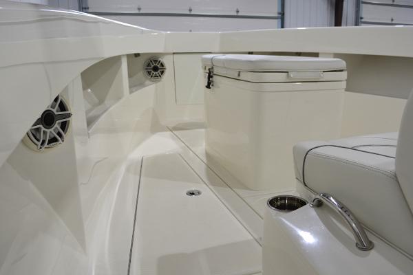 Slide: The Image of 2020 SeaVee 322z boat interior with seating, speakers, and storage compartment. - 18