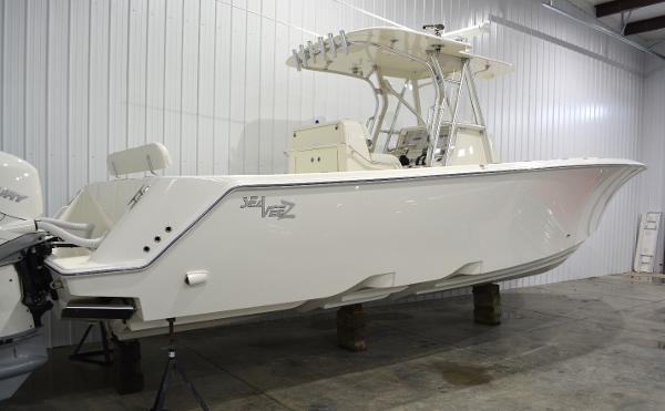 Slide: The Image of 2020 SeaVee 322z boat in a showroom, side view, white hull. - 2