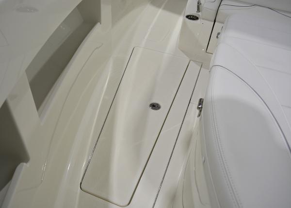 Slide: The Image of 2020 SeaVee 322z boat interior with sleek white seating and storage compartment. - 26