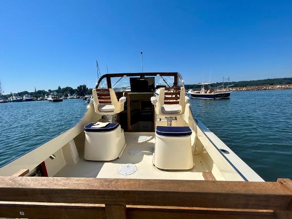 Slide: The Image of 2021 Seaway 21 Seafarer Cuddy boat on calm water, featuring spacious seating and clear blue sky. - 7