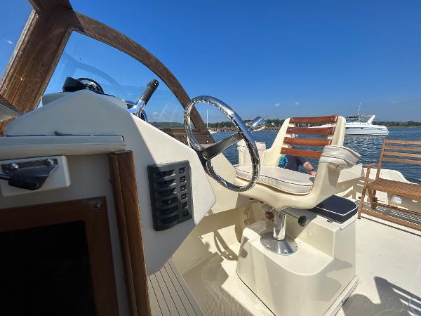 Slide: The Image of 2021 Seaway 21 Seafarer Cuddy helm with wooden accents and steering wheel. - 8