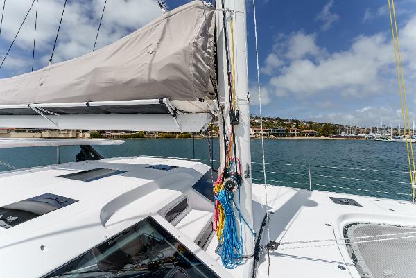 Slide: The Image of 2024 Seawind 1600 sailboat deck with clear sky and waterfront view. - 11