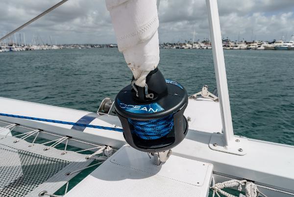 Slide: The Image of Seawind 1600 sailboat deck with winch, 2024 model, in a marina setting. - 13
