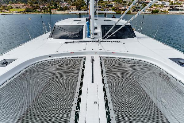 Slide: The Image of 2024 Seawind 1600 catamaran deck with netting, on calm water. - 15