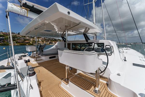 Slide: The Image of 2024 Seawind 1600 catamaran deck with dual steering wheels and modern design. - 16
