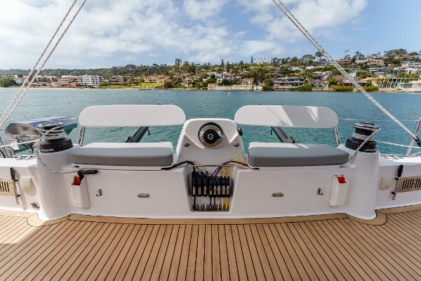 Slide: The Image of 2024 Seawind 1600 yacht deck with seating, overlooking scenic waterfront homes. - 19