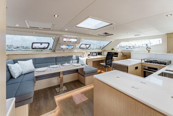 Slide: The Image of Luxurious interior of 2024 Seawind 1600 catamaran with modern kitchen and seating area. - 2
