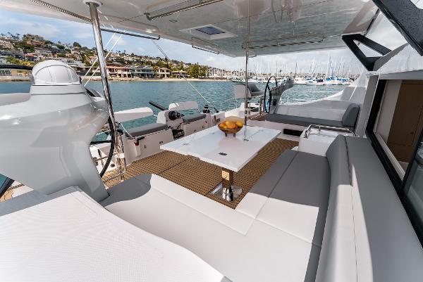 Slide: The Image of Luxurious 2024 Seawind 1600 catamaran with spacious outdoor seating and dining area. - 21
