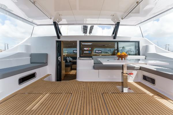 Slide: The Image of Luxurious 2024 Seawind 1600 catamaran interior with modern seating and dining area. - 22