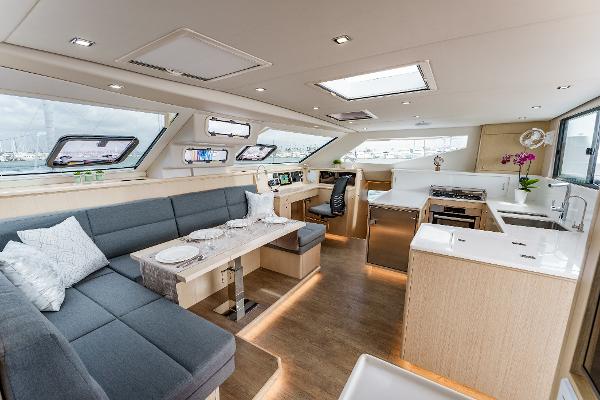 Slide: The Image of Luxurious interior of 2024 Seawind 1600 catamaran with modern kitchen and seating area. - 23