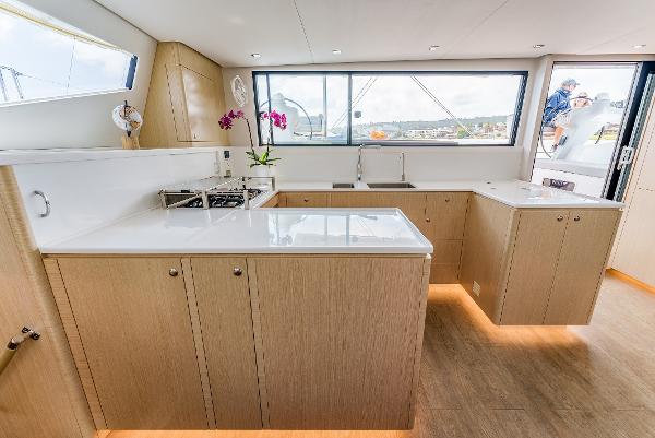 Slide: The Image of Modern kitchen interior of 2024 Seawind 1600 yacht with sleek cabinetry and large windows. - 25