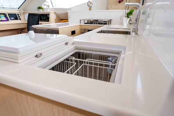 Slide: The Image of Modern kitchen interior of 2024 Seawind 1600 yacht with sleek countertops and built-in appliances. - 26