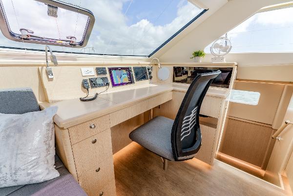 Slide: The Image of Luxurious Seawind 1600 yacht interior with navigation desk, modern chair, and panoramic windows, 2024 model. - 27