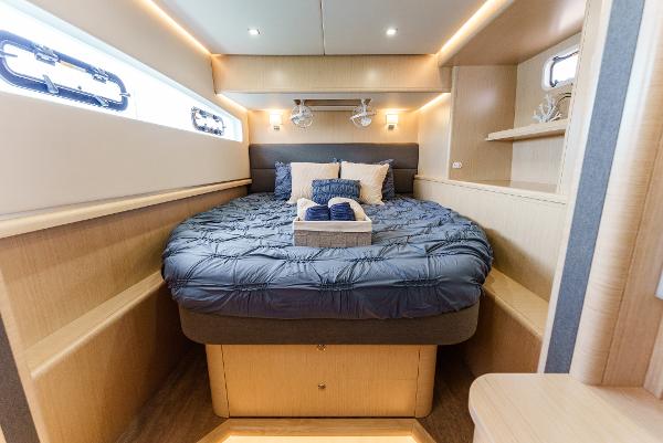 Slide: The Image of Luxurious 2024 Seawind 1600 yacht cabin with cozy bed and modern lighting. - 3