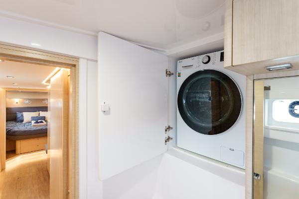 Slide: The Image of Laundry area in 2024 Seawind 1600 yacht with washer-dryer and cozy cabin view. - 33