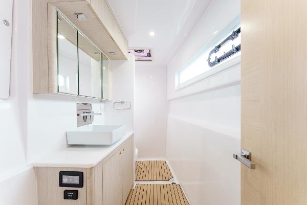 Slide: The Image of Modern bathroom interior on 2024 Seawind 1600 yacht with sleek fixtures and wood accents. - 34