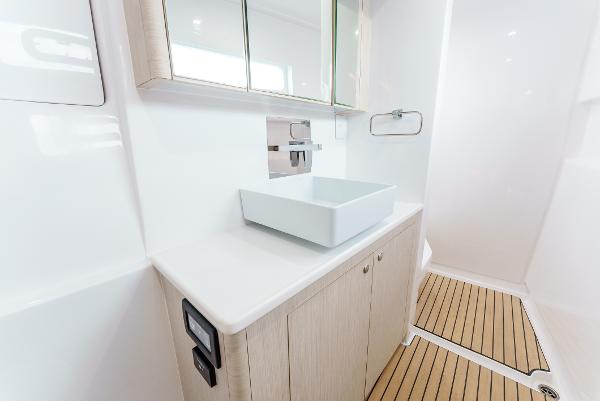 Slide: The Image of Modern bathroom interior of 2024 Seawind 1600 yacht with sleek sink and wooden flooring. - 35