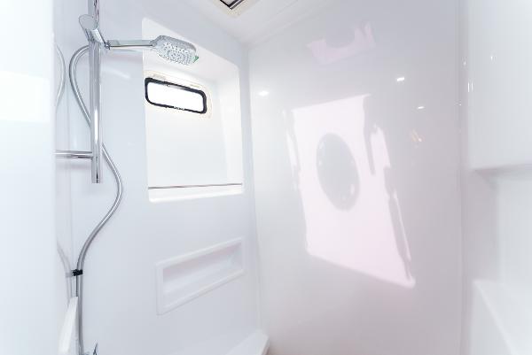 Slide: The Image of Modern shower area in 2024 Seawind 1600 yacht, featuring sleek design and window. - 36