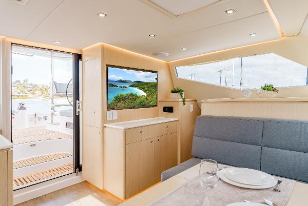 Slide: The Image of Luxurious interior of 2024 Seawind 1600 catamaran with modern dining area and scenic view. - 38