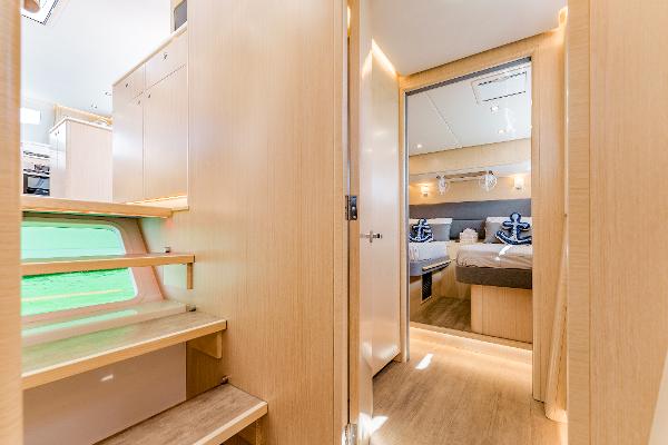 Slide: The Image of Interior of 2024 Seawind 1600 catamaran, featuring modern wood finishes and cozy bedroom. - 39