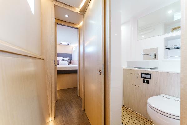 Slide: The Image of 2024 Seawind 1600 yacht interior with modern bathroom and cozy bedroom. - 42