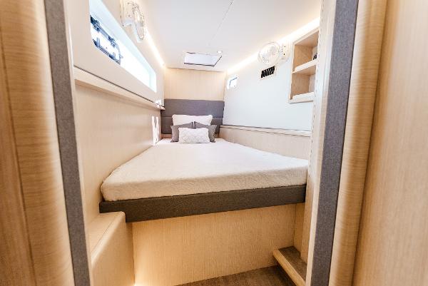 Slide: The Image of Luxurious cabin interior of 2024 Seawind 1600 catamaran, featuring a cozy bed and modern design. - 44