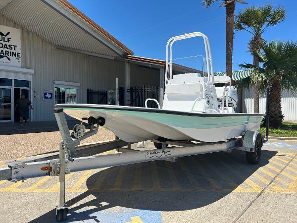 Slide: The Image of 2024 Shallow Sport 18 Sport boat on trailer outside Gulf Coast Marine. - 1