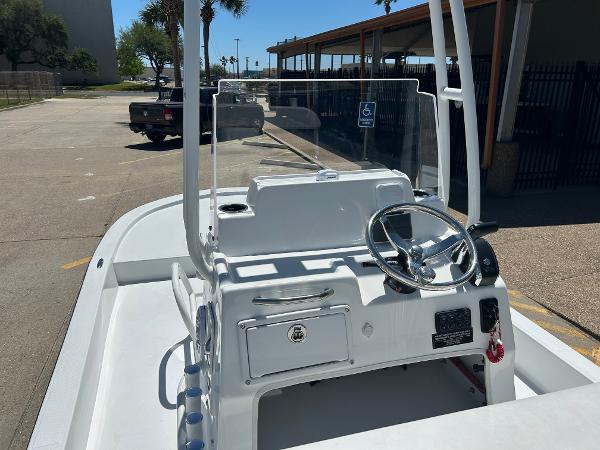 Slide: The Image of 2024 Shallow Sport 18 Sport boat console with steering wheel and controls. - 12