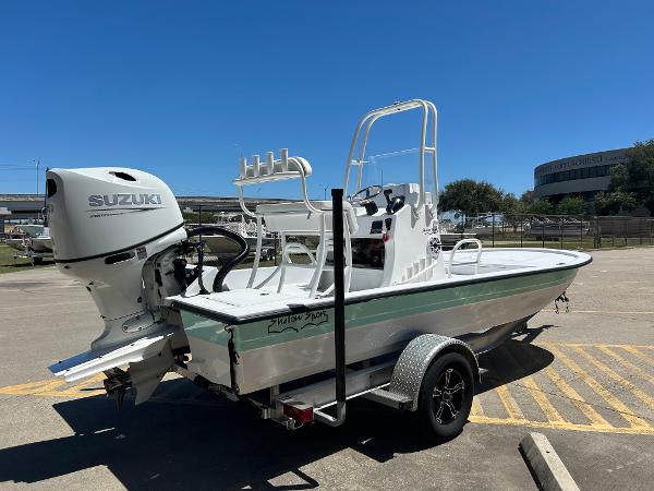 Slide: The Image of 2024 Shallow Sport 18 Sport boat with Suzuki outboard motor on trailer. - 2