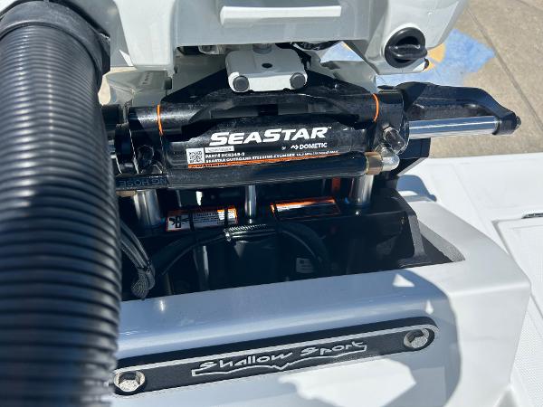 Slide: The Image of Close-up of 2024 Shallow Sport 18 Sport boat with SeaStar hydraulic steering system. - 5