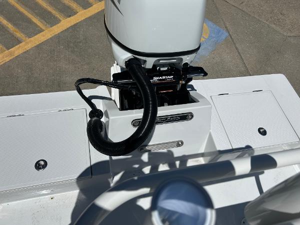 Slide: The Image of 2024 Shallow Sport 18 Sport boat engine and deck view. - 6