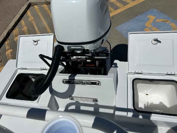 Slide: The Image of 2024 Shallow Sport 18 Sport boat engine and storage compartments. - 7