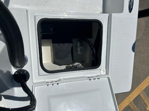 Slide: The Image of 2024 Shallow Sport 18 Sport boat storage compartment with open hatch. - 8