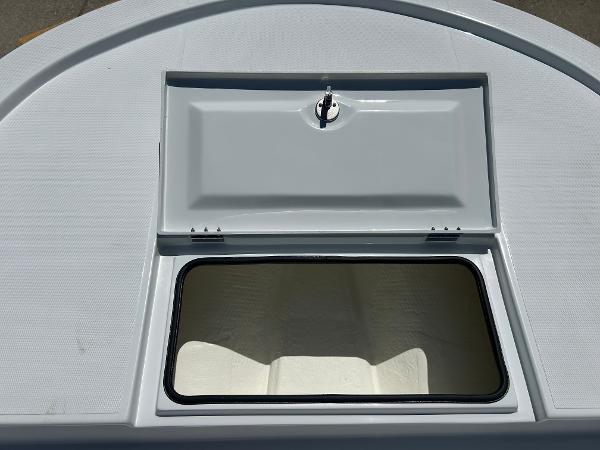 Slide: The Image of 2024 Shallow Sport 18 Sport boat storage compartment with open hatch. - 9