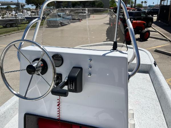 Slide: The Image of 2024 Shallow Stalker CAT-204 boat console with steering wheel and controls. - 16