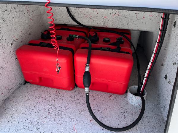 Slide: The Image of Red fuel tanks in the storage compartment of a 2024 Shallow Stalker CAT-204 boat. - 17