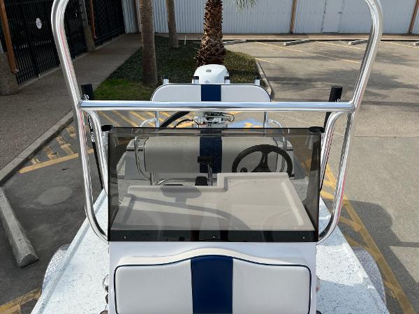 Slide: The Image of 2024 Shallow Stalker SS-17 Sportsman boat console and steering wheel in a parking lot. - 12