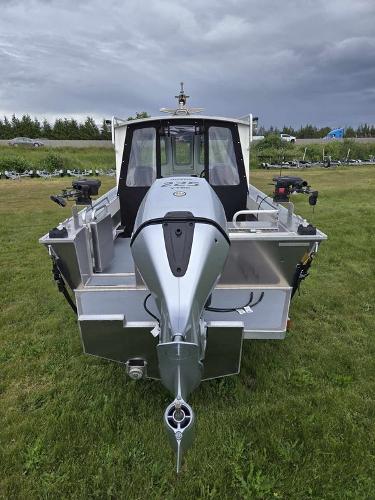 Slide: The Image of 2024 Silver Streak RENFREW boat with outboard motor on grassy field. - 4