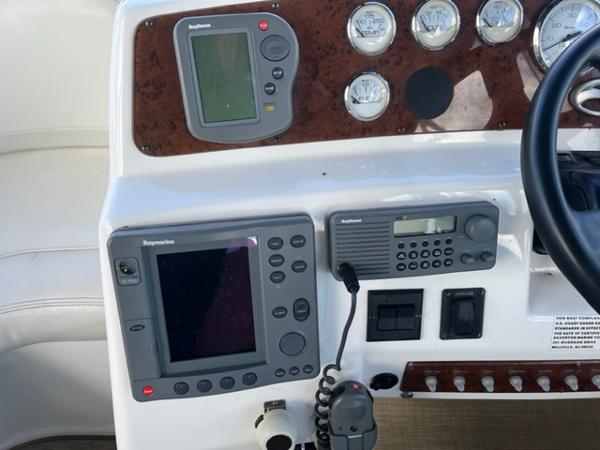 Slide: The Image of 2001 Silverton 330 Sport Bridge dashboard with navigation and communication equipment. - 10